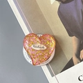 Macro detail of heart-shaped phone grip with pink glitter and handmade metal label - Magnetic Colorful Sequin Heart Style No.12