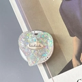 Macro shot of glittery heart phone grip with handmade metal logo on resin surface - Magnetic Colorful Sequin Heart Style No.14