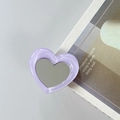 Macro shot of purple heart-shaped phone grip with marble texture and integrated mirror - Purple