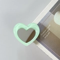 Detail shot of heart-shaped phone grip tok with mint green border and built-in mirror - Light Green
