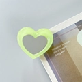 Close-up of heart-shaped phone grip with pale green frame and integrated makeup mirror - Fluorescent Green