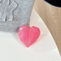 Macro detail of a 3D pink laser heart-shaped magnetic phone grip with geometric facets - Adhesive Grip / Iridescent Rose Red