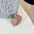 Detail view of the holographic laser heart-shaped phone grip with multi-faceted geometry - Adhesive Grip / Laser Brown