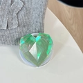 Macro detail of aurora green laser heart-shaped phone grip with 3D faceted texture - Magnetic / Iridescent Green