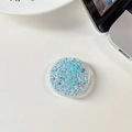 Macro detail of round light blue phone grip holder with sparkling glitter star sequins - Glue Grip - Starry Sequins - Blue