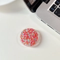 Macro detail of round phone grip with red and pink glitter sequins on a white desk - Glue Grip - Starry Sequins - Red