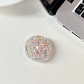 Close-up of circular phone grip featuring colorful star sequins and silver glitter detail - Glue Grip - Starry Sequins - Multicolor