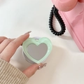 Detail of mint green heart-shaped phone grip with built-in mirror and compact design - Light Green