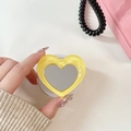 Macro shot of yellow heart-shaped folding phone grip with built-in mirror detail - Dark Yellow