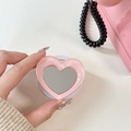 Support de téléphone en forme de cœur rose avec miroir sur fond de style rétro - Rose