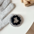 Close-up of a bear-pattern phone grip with rhinestones on a cozy knit background - Black (Jelly Bear Mirror / White Zirconia)