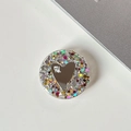 Close-up of a round glittery phone griptok with a heart mirror and mi ne. text - Transparent Stand - Colorful Sequins Heart Mirror - No. 4