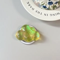 Detail of laser green cloud phone grip showing iridescent finish and expandable base - Magnetic Cloud / Yellow
