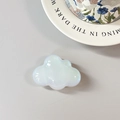 Detail of a cloud-shaped phone socket with iridescent opal finish on a gray background - Adhesive Cloud / White