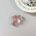 Close-up of a pink iridescent bear-shaped phone grip with a laser aurora finish - Adhesive Cloud / Pink