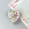 Macro shot of heart-shaped phone grip with colorful sequins and handmade resin detail - Style 1