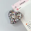 Macro view of heart-shaped phone grip with glitter resin and handmade metal plate - Style 2 (Pattern)