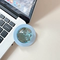 Macro detail of a light blue crystal phone grip on a laptop, showing diamond-cut facets - Blue