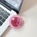 Detail view of pink crystal gemstone collapsible phone grip on a silver laptop surface - Rose Red