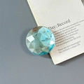 Close-up of a light blue multifaceted crystal magnetic phone grip with a glossy finish - Adhesive-Large Round Rhinestone-Blue
