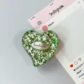 Macro di supporto per telefono a cuore con glitter e targhetta handmade su sfondo chiaro - Stile 11
