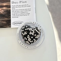 Detailed macro view of heart-shaped magnetic phone grip with black and white rhinestones - Black / Magnetic Model
