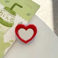 Macro detail of a red heart-shaped pop socket phone grip with a retractable base - Red