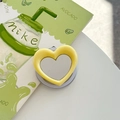 Detail shot of heart-shaped magnetic phone grip with mirror in lemon yellow finish - Light Yellow