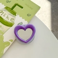 Macro view of purple heart-shaped magnetic phone grip with integrated makeup mirror - Dark Purple