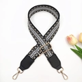 Detail of adjustable embroidered bag strap with ethnic patterns and gold swivel hooks - Black Base Cream + Black