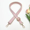 Detailed close-up of pink and beige jacquard strap with gold-tone metal hooks - Pink and Khaki Edge