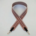 Macro shot of geometric twill fabric strap with golden metal swivel hooks and leather ends - Brown with Black Leather (Silver Buckle)