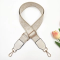 Detail of adjustable geometric jacquard bag strap with gold metal hooks and white leather - Gold Buckle / Beige White + White Leather