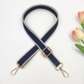 Detail view of navy and beige jacquard adjustable bag strap with gold metal hardware - Dark Blue and Beige Edge