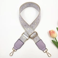 Close-up of adjustable purple ethnic jacquard strap with gold metal hooks and leather accents - Beige Light Purple + Purple Leather