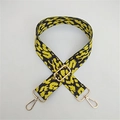 Close-up of adjustable leopard print bag strap with durable gold metal hooks - Yellow