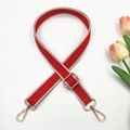 Detail of red and cream geometric pattern woven bag strap with golden metal swivel hooks - Red and Beige Edge