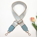 Macro detail of blue geometric jacquard bag strap with gold buckle and tulip decoration - Beige Light Blue + Light Blue Leather