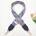 Close-up of ethnic geometric blue and white embroidered bag strap with gold metal hooks - Beige Royal Blue + Blue Leather
