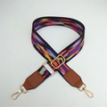 Close-up of adjustable ethnic style woven bag strap with colorful patterns and gold hooks - Black Border Colorful Clouds With Brown Leather End