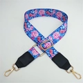 Close-up of blue floral bag strap with pink flowers and gold metal swivel hooks - Blue Flower With Black Leather End