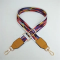 Detail of colorful wavy pattern nylon purse strap with gold metal hooks and yellow leather ends - White Border Colorful Clouds With Yellow Leather End