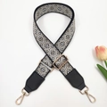 Detail of adjustable geometric jacquard bag strap with black leather and gold hardware - Black Beige + Black Leather