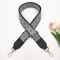 Detail of bohemian jacquard bag strap with geometric pattern and gold hardware - Black Light Blue + Black Leather