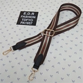 Detail of adjustable nylon strap with green and red stripes and gold lobster clasps - Brown Red Green Stripe