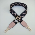 Détail d'une large bandoulière réglable avec motif zigzag rose et fermoir doré brillant - Motif Noir et Rose + Bordure en Cuir Rose