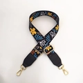 Detail of adjustable floral canvas strap with gold hardware and black leather ends - Black Floral + Black