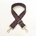 Detail of adjustable woven bag strap with colorful geometric diamond patterns and gold hooks - Maze Pattern