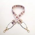 Close-up of ethnic floral embroidery wide strap with gold metal lobster clasps - White Floral Plant + White