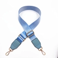 Detail of light blue nylon bag strap with gold metal buckles and leather reinforcement - Lake Blue